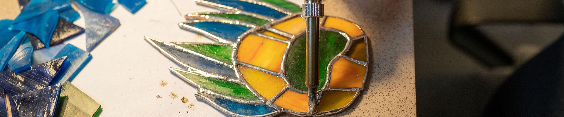A piece of stained glass being soldered