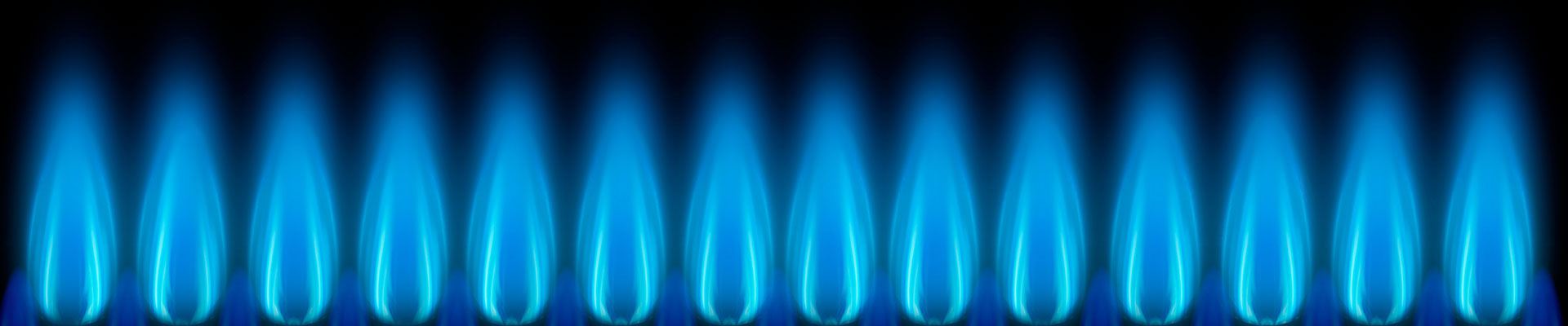 A row of gas flames on a black background