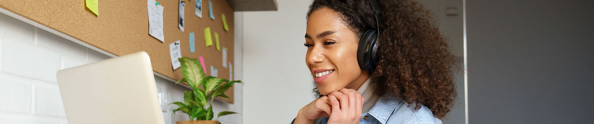 A female student at home learning on her laptop