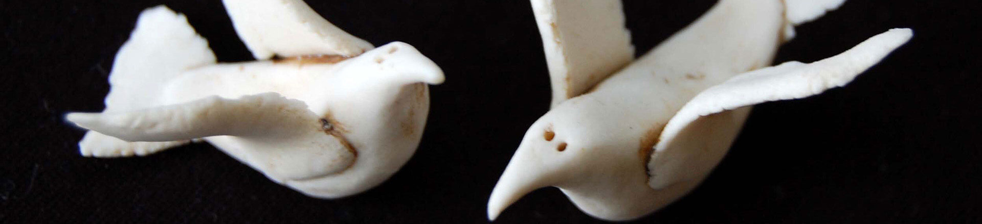 Porcelain birds made by a student on a black background