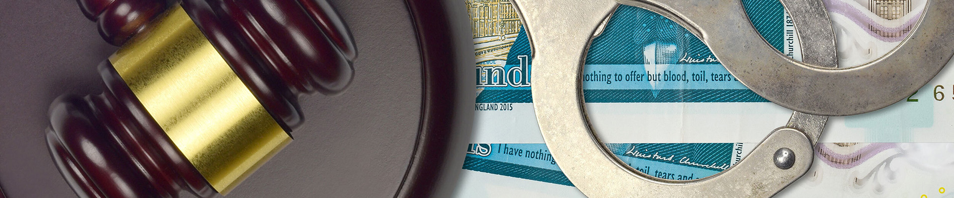 A gavel, handcuffs and £5 notes