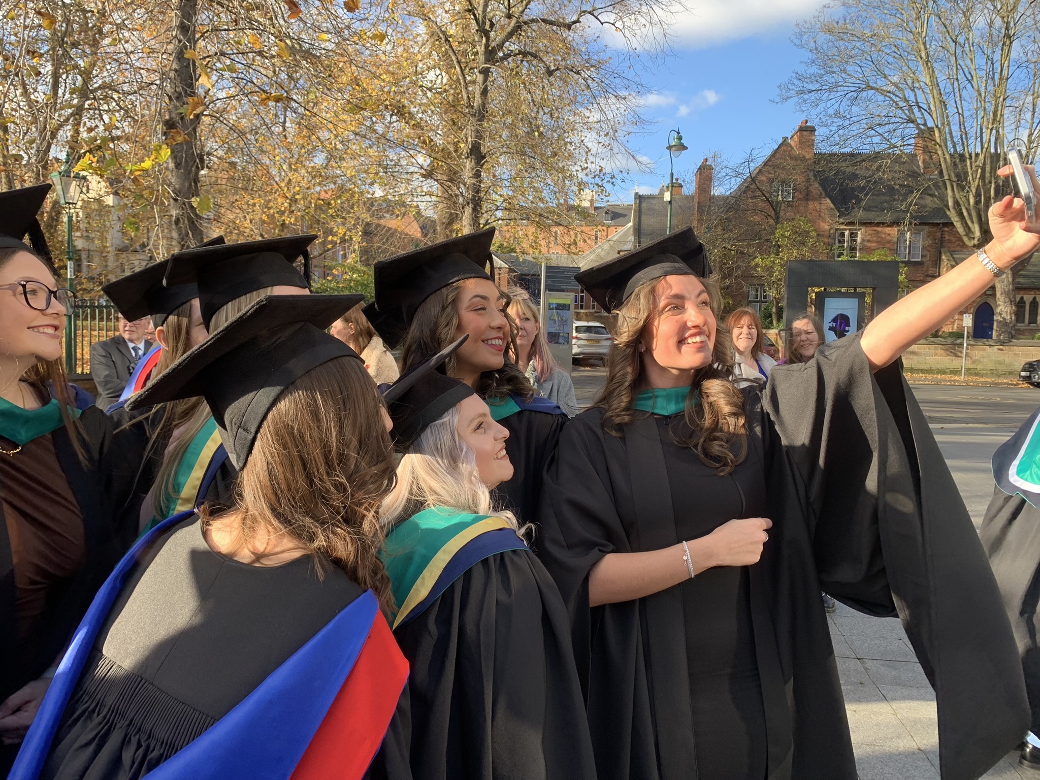 A group of graduating students stood together posing for a picture