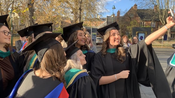 A group of graduating students stood together posing for a picture