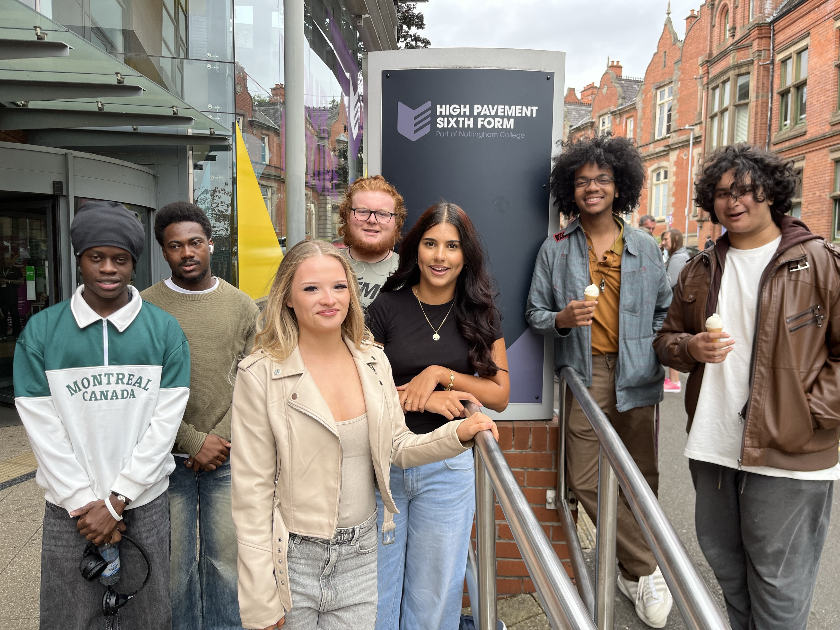 Nottingham College GCSE students smiling in front of the High Pavement sign