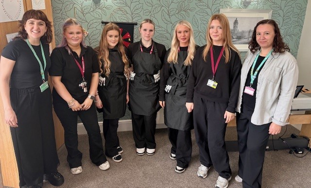 Staff and students smiling in a group picture
