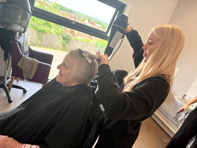 care home resident getting their hair dried