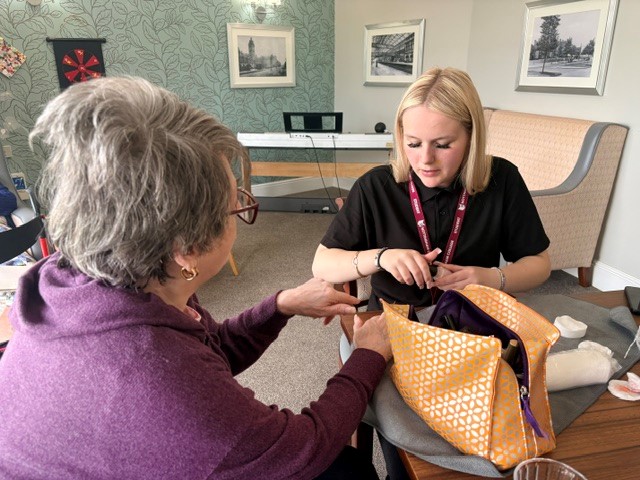 Care home resident picking a nail colour