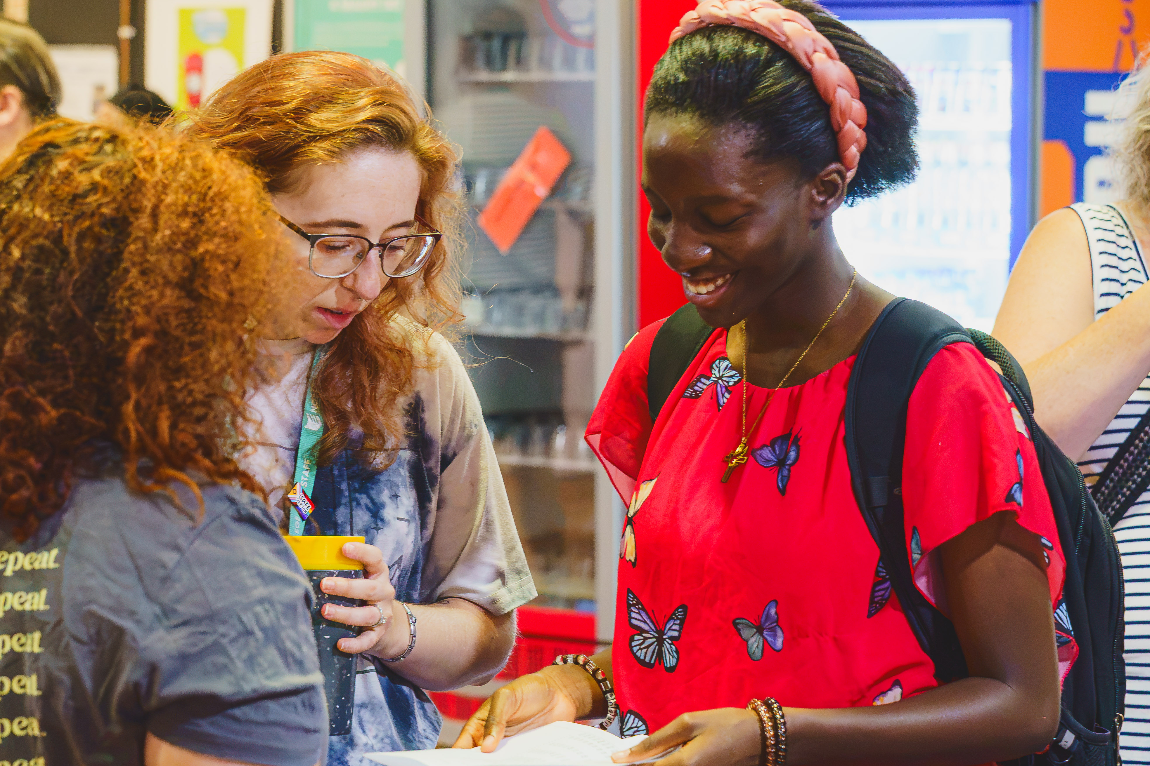 Student happily reads their A level results with a staff member