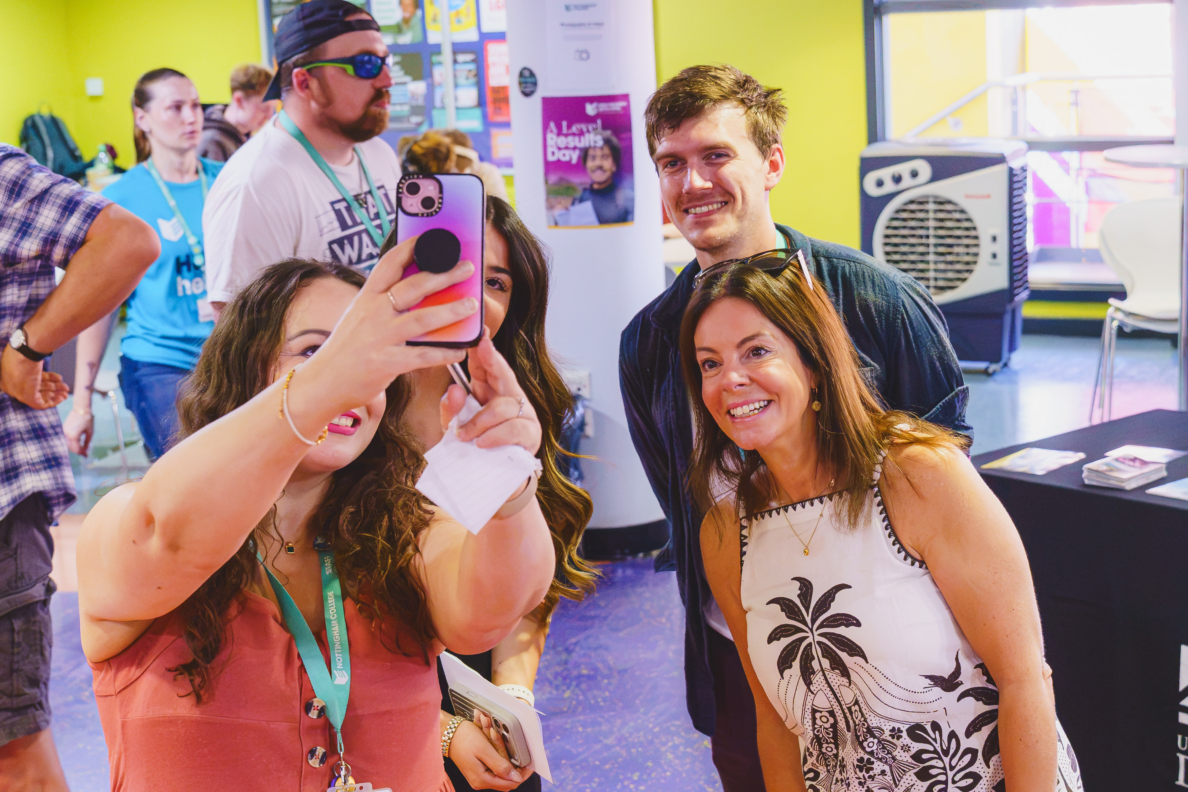 Staff pose for a picture with happy students