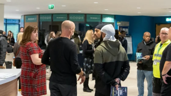 Visitors at an Open Evening at Basford standing in the main reception area.