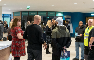 Visitors at an Open Evening at Basford standing in the main reception area.