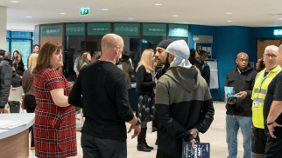 Visitors at an Open Evening at Basford standing in the main reception area.