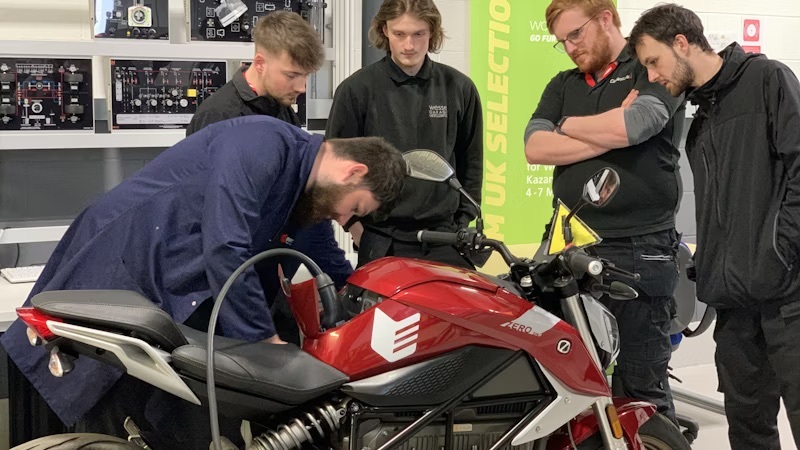 Students working on an electric motorbike in a workshop at Emtec in Ruddington.