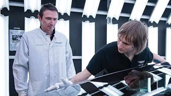 An assessor inspecting the work of a bodywork repair apprenticeship in a workshop