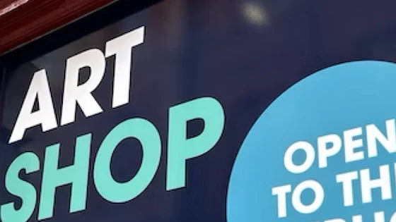 Exterior signage of the Art shop showing open to the public