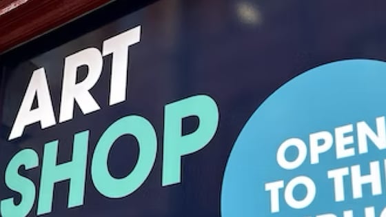 Exterior signage of the Art shop showing open to the public