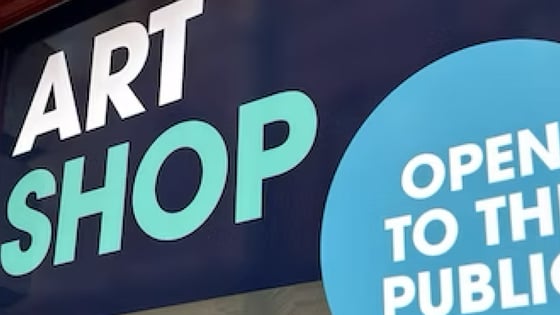 Exterior signage of the Art shop showing open to the public