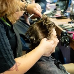 Hairdressing working on a client's hair in a salon