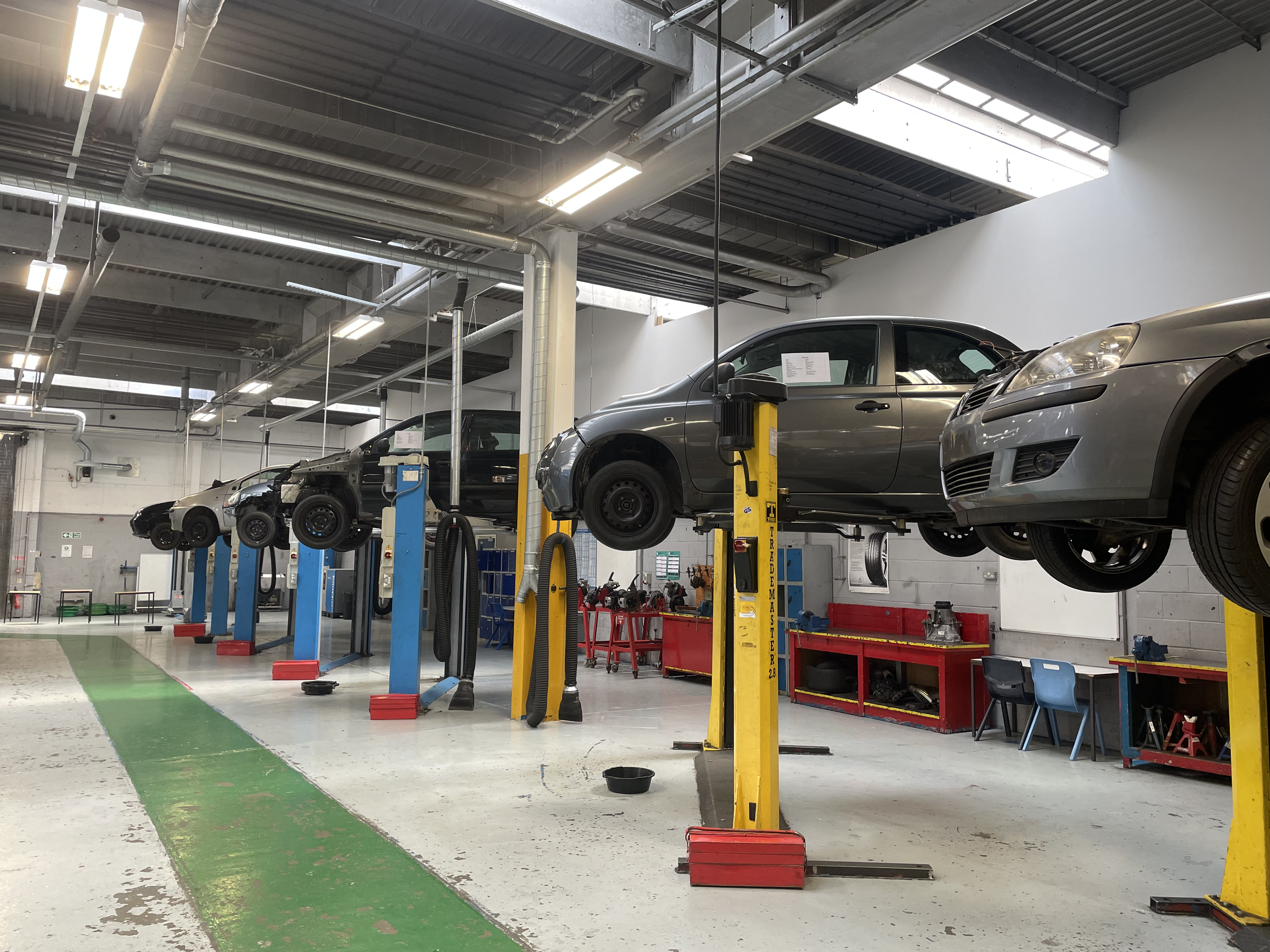 Cars in a automotive workshop on lifts