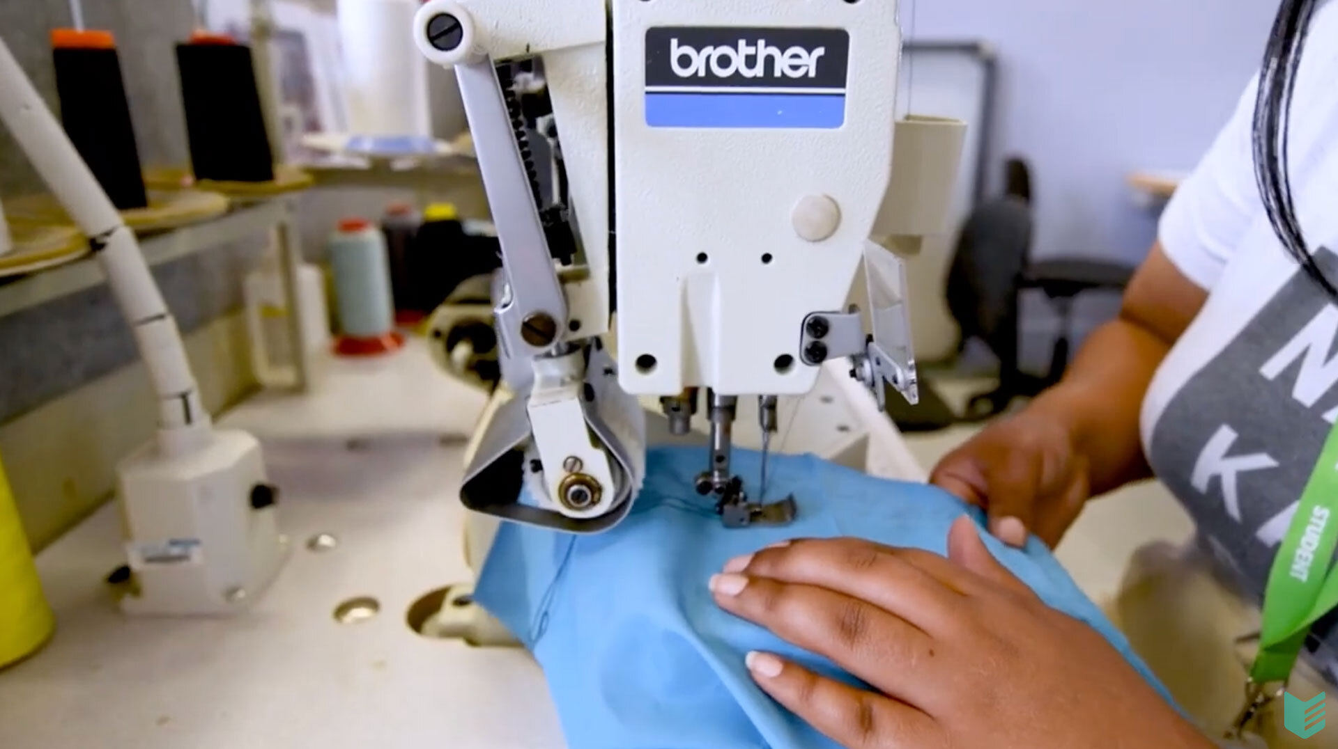 Fashion student using a sewing machine to sew some material