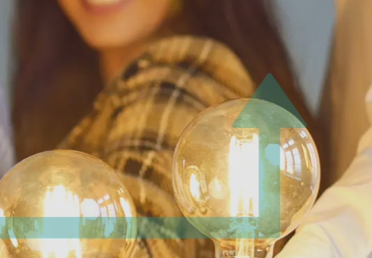 Lightblubs illuminated with people standing behind them