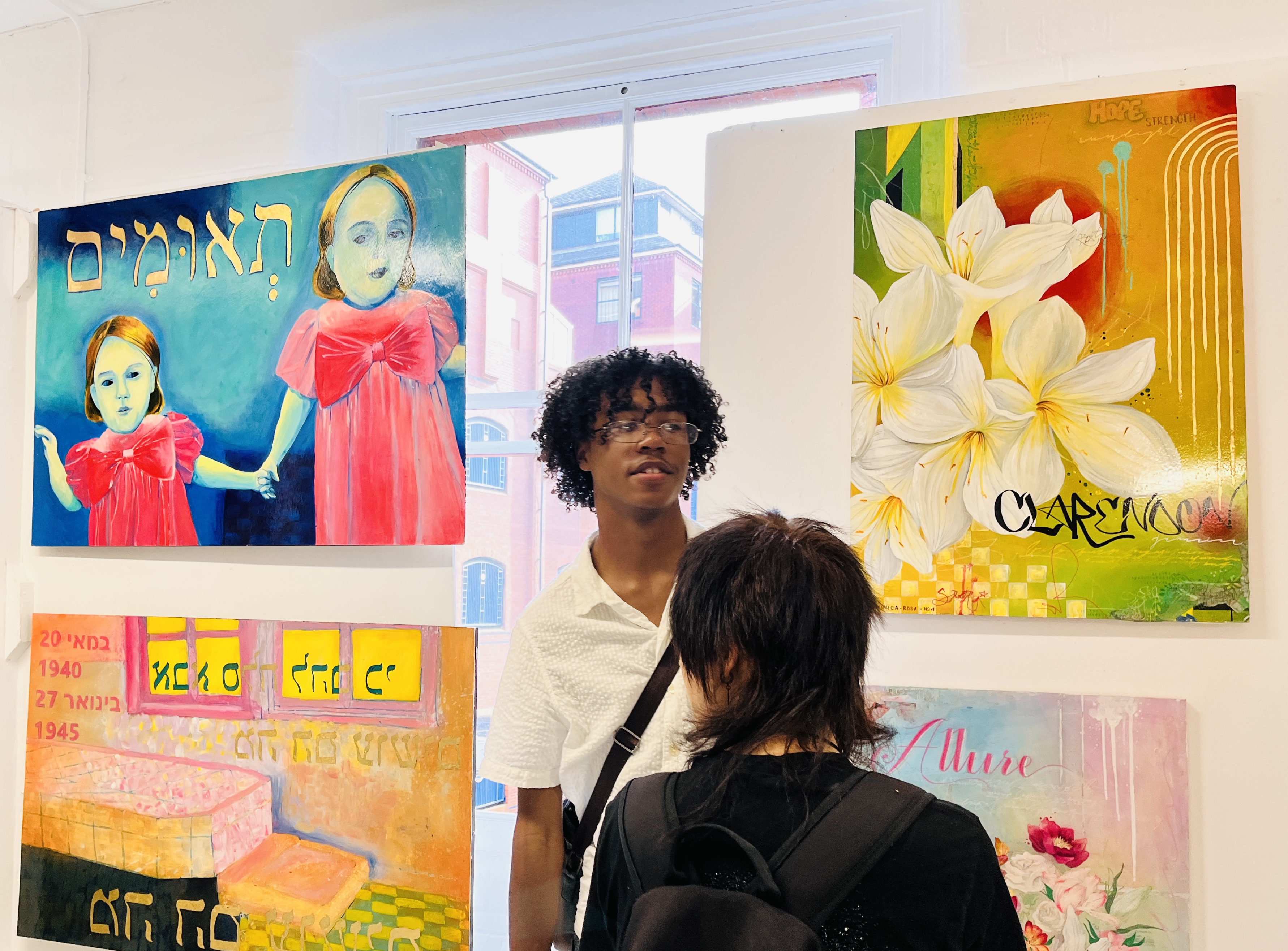 A student stood in front of 4 different paintings