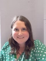 A member of staff smiling