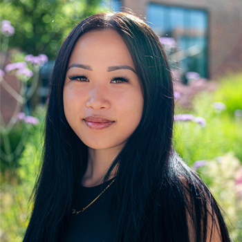 A member of staff smiling outside