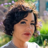 A picture of a woman smiling outside