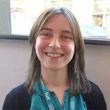 A member of staff smiling