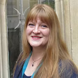 A member of staff smiling