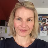 A member of staff smiling