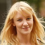 A member of staff smiling