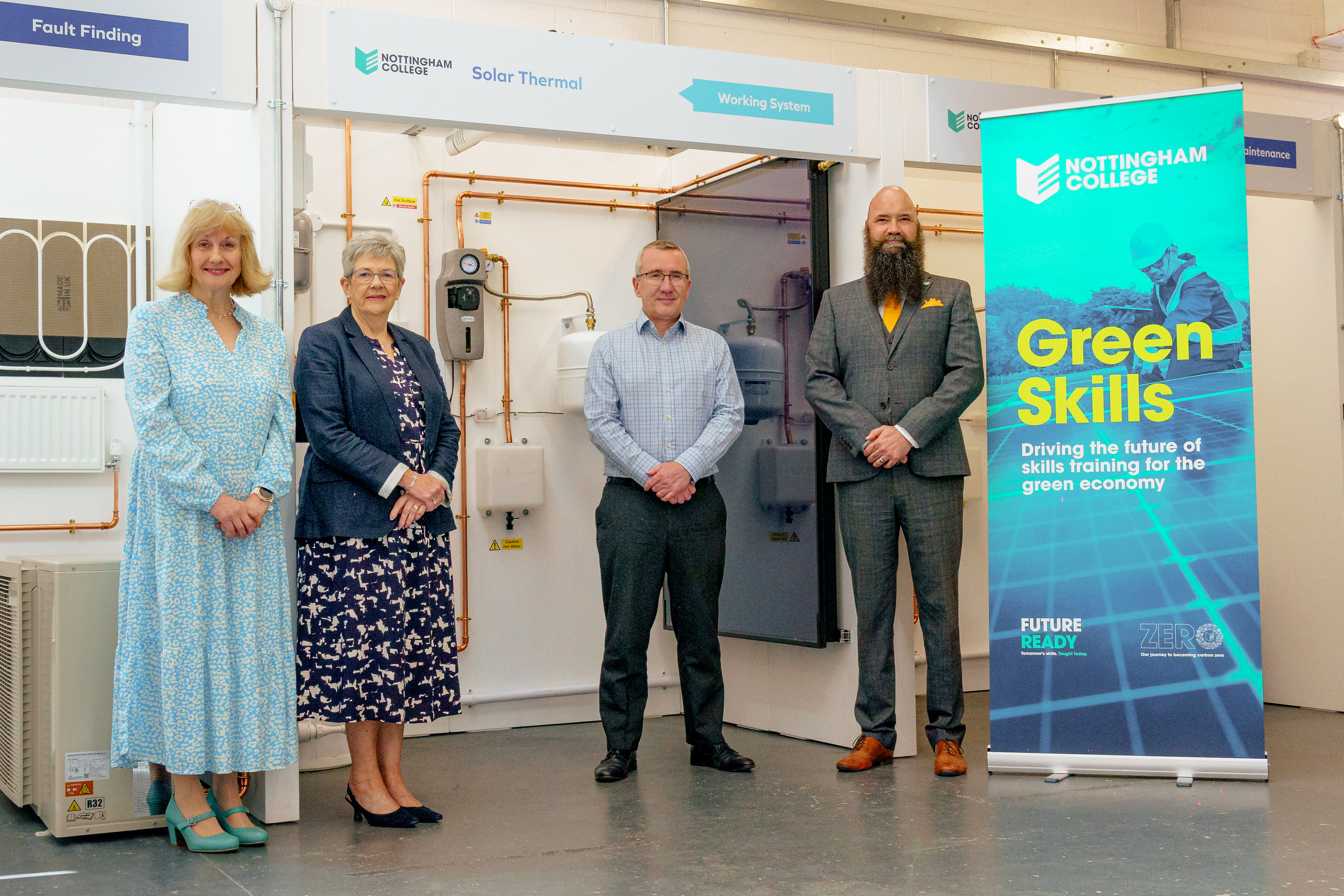 Four members of staff stood in front of equipment in the green skills centre