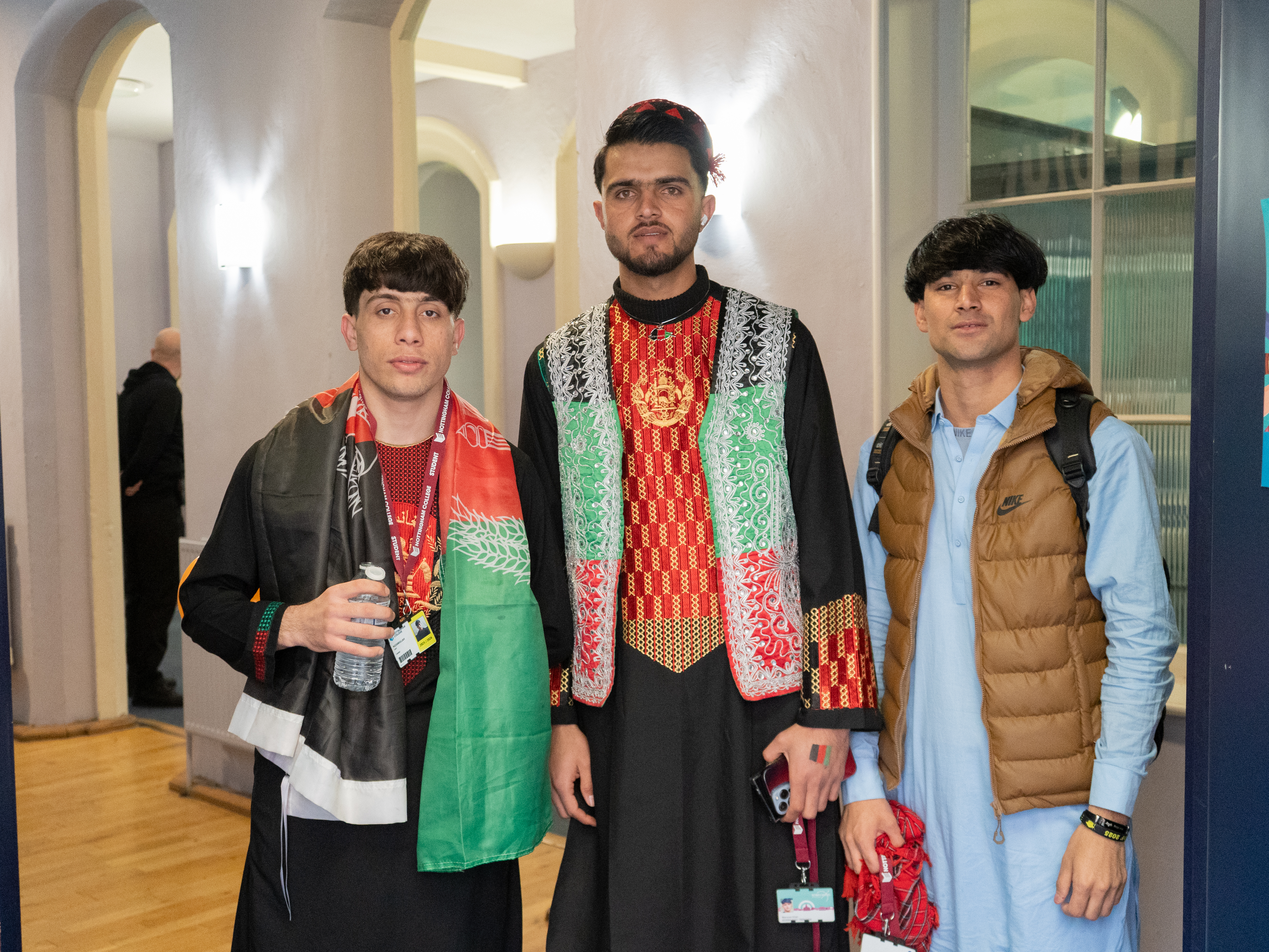 Adams - group of friends in traditional outfits and flags