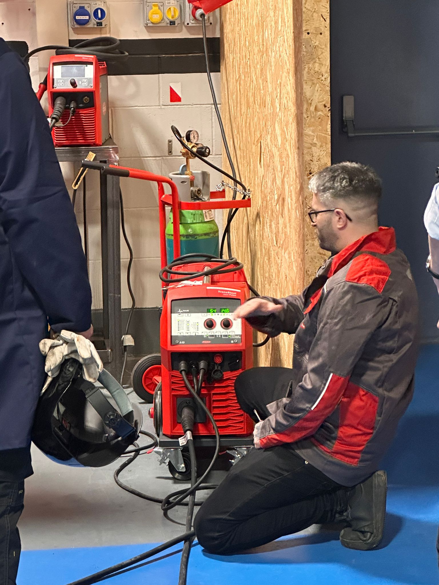 Apprentices at a demonstration of welding equipment