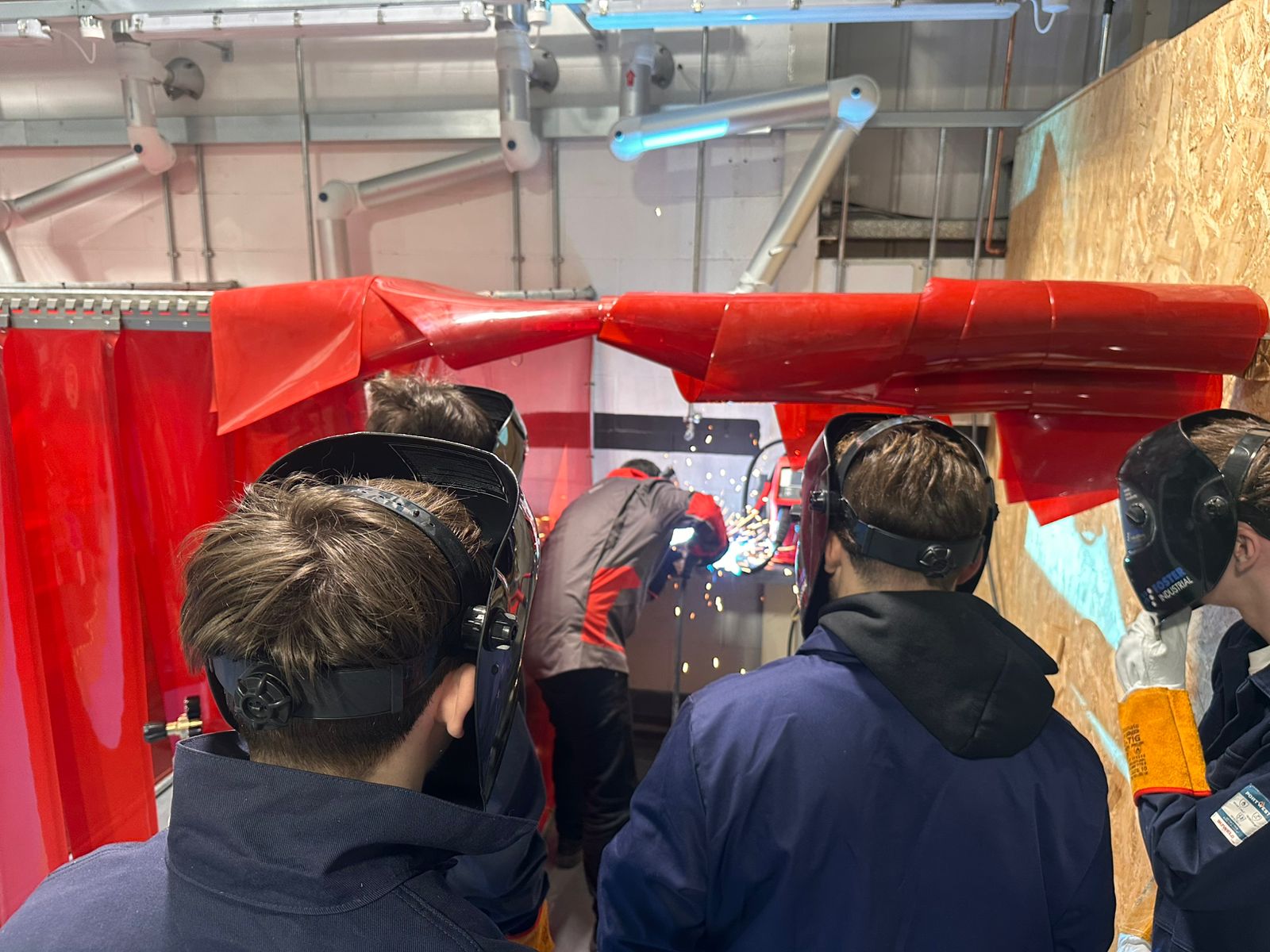 Apprentices at a demonstration of welding equipment
