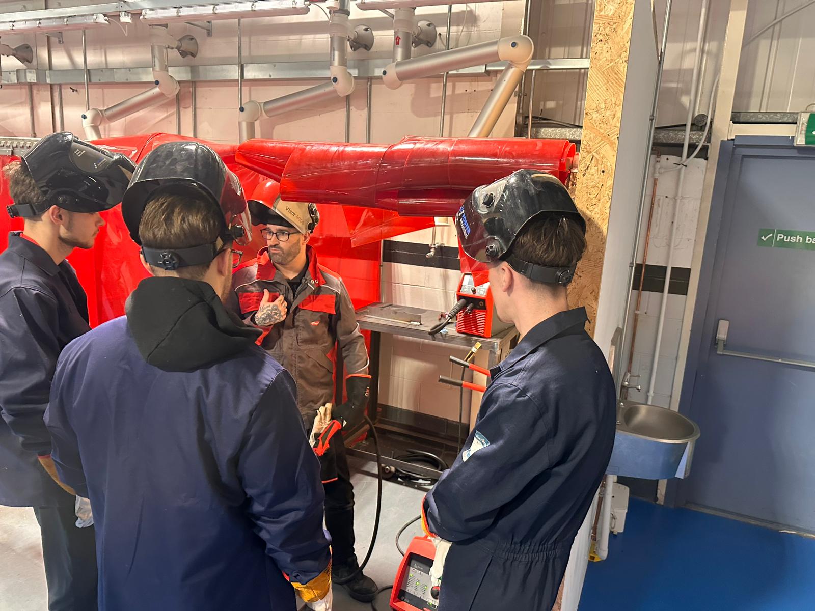 Apprentices at a demonstration of welding equipment