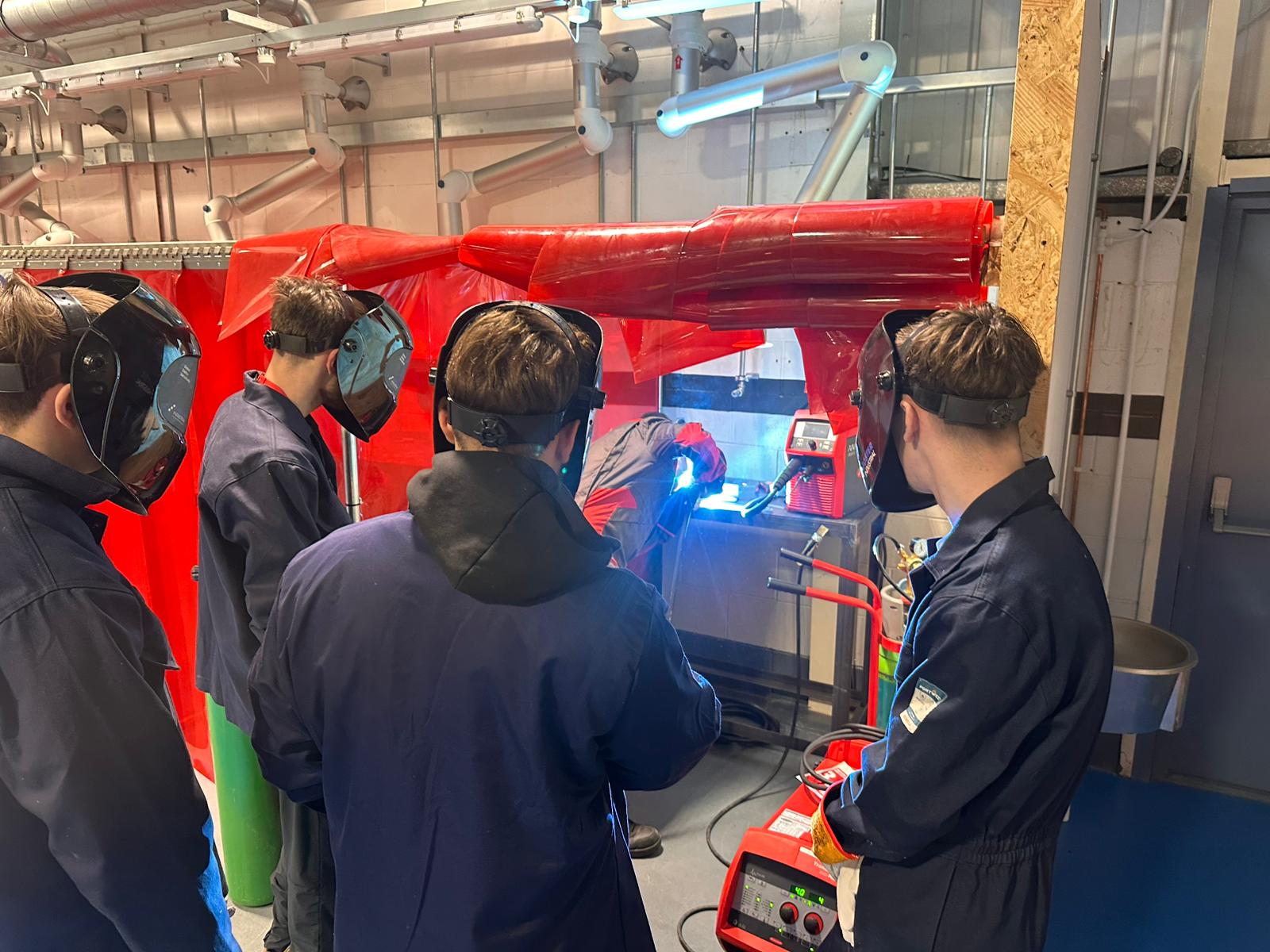 Apprentices at a demonstration of welding equipment