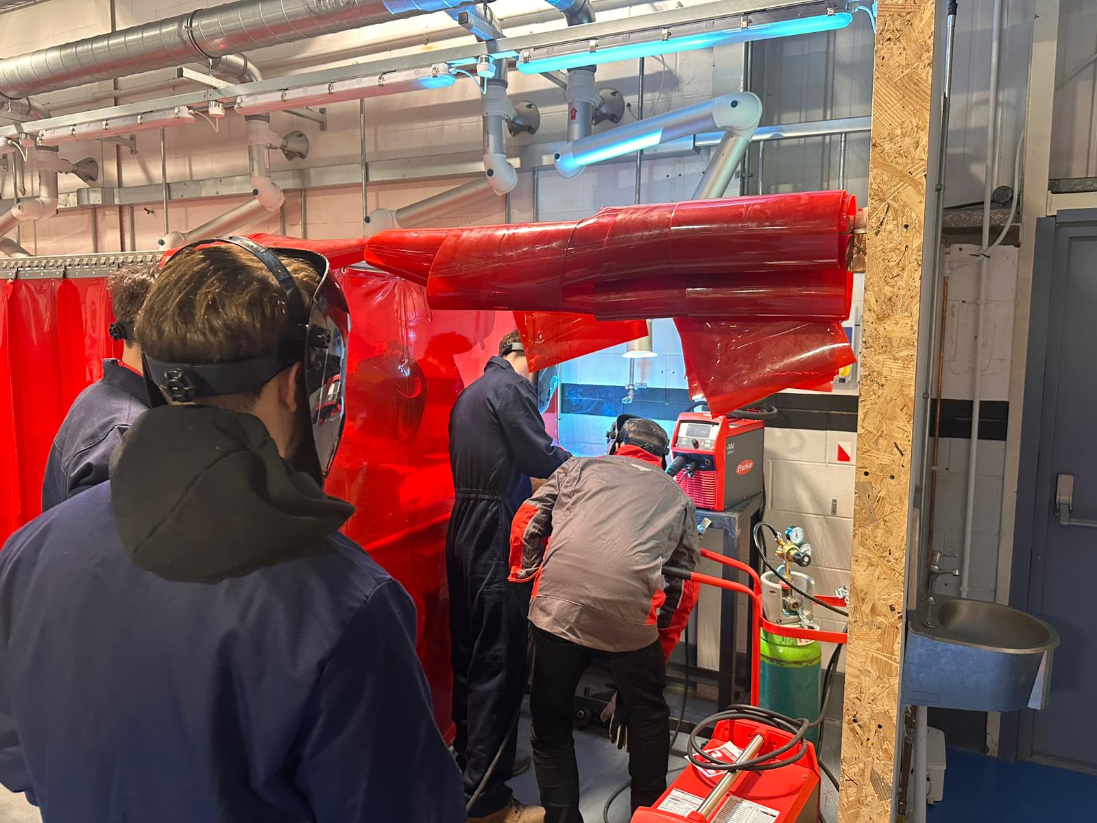 Apprentices at a demonstration of welding equipment
