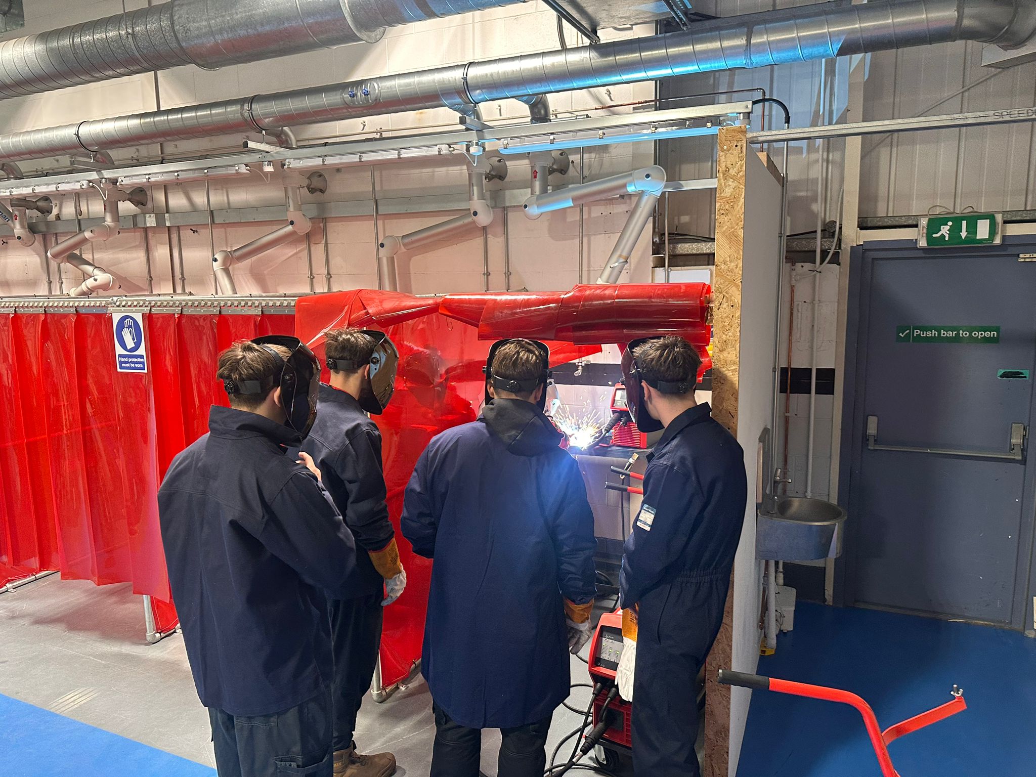 Apprentices at a demonstration of welding equipment