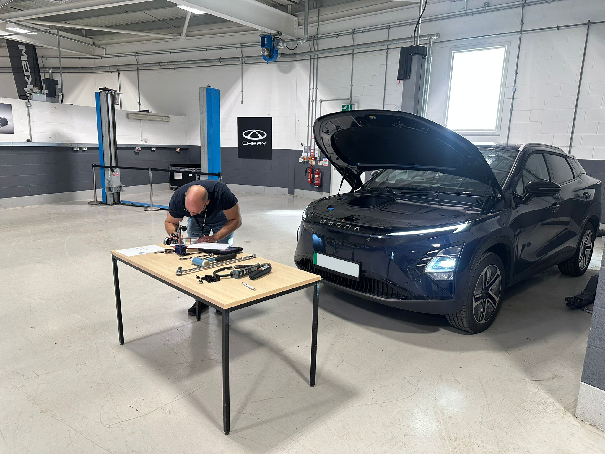 Car Tech assessing a vehicle