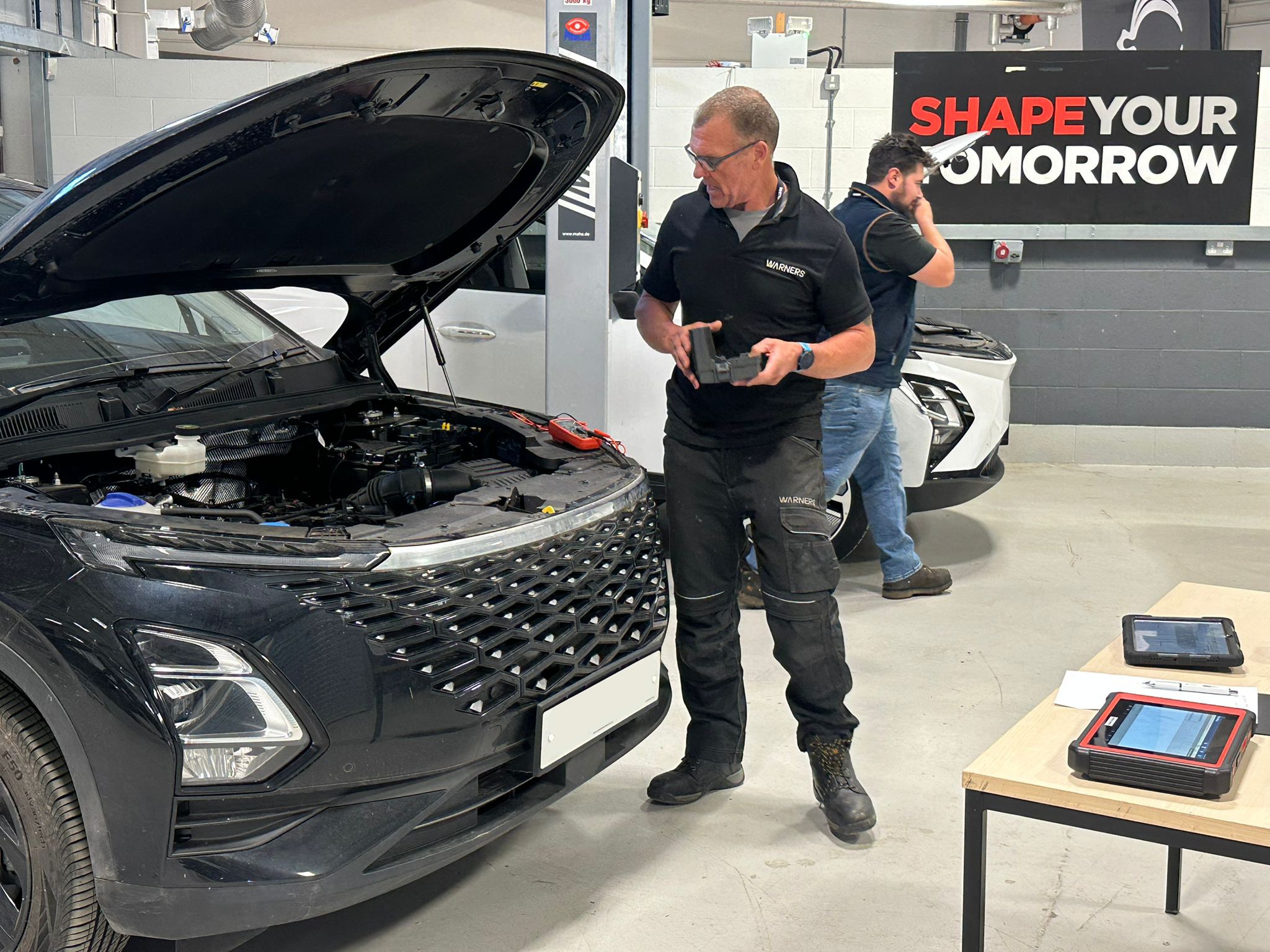 Car Tech assessing a vehicle