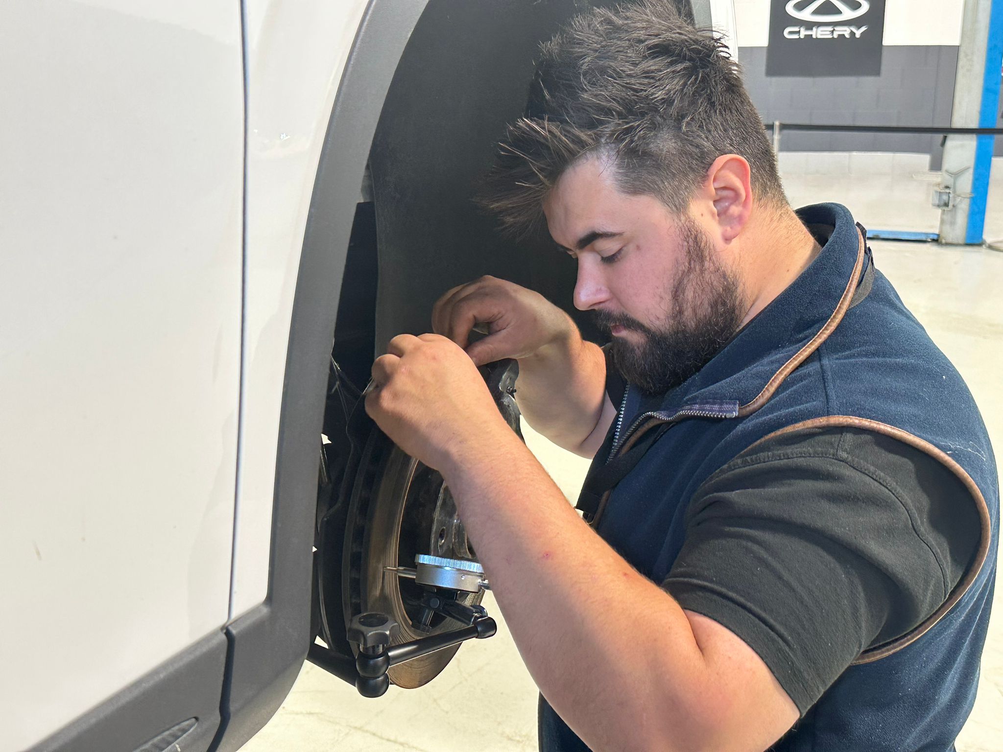 Car Tech assessing a vehicle