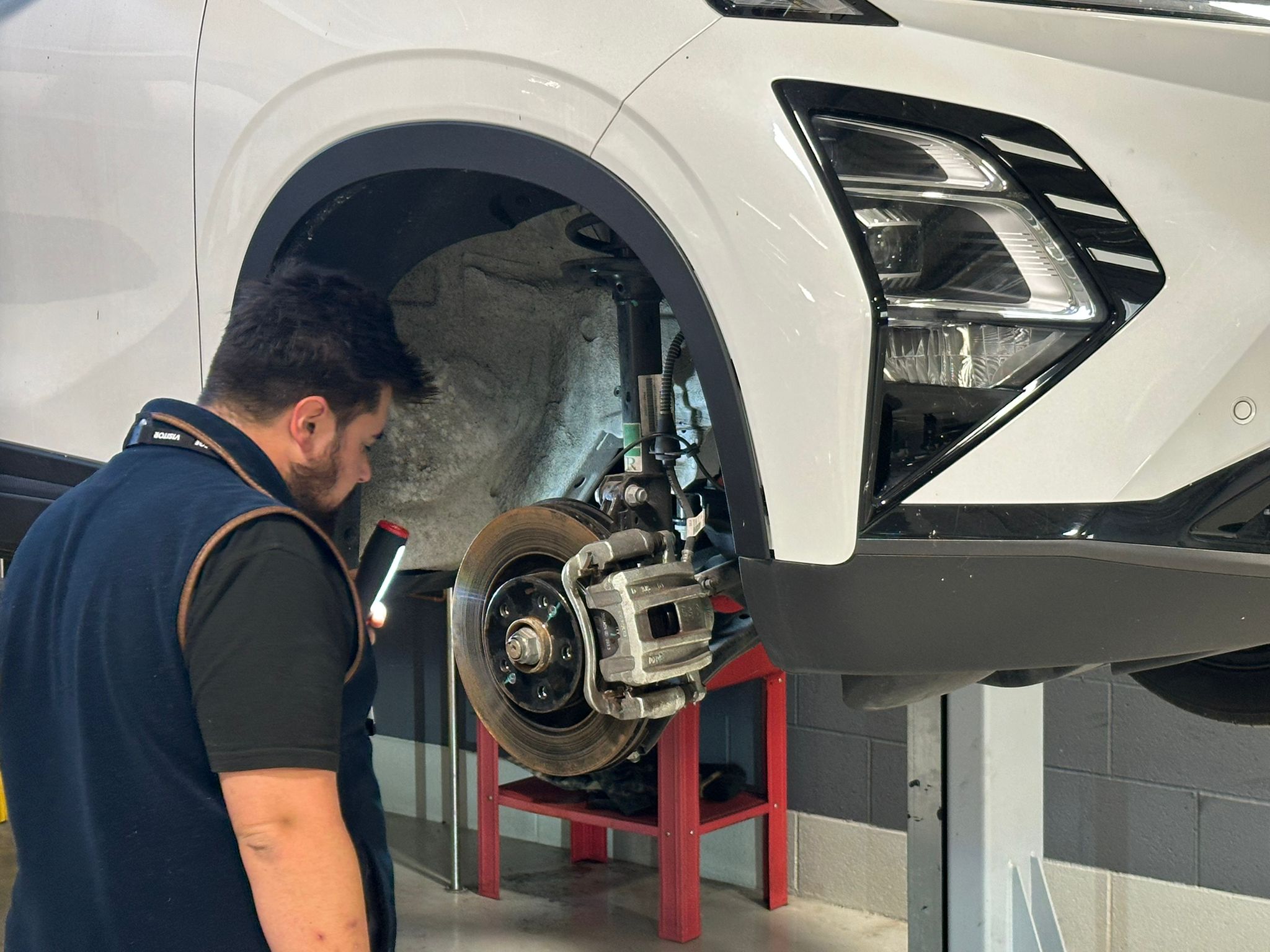 Car Tech assessing a vehicle