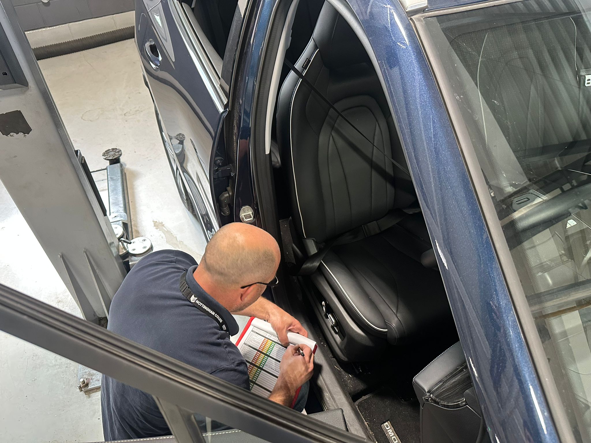 Car Tech assessing a vehicle