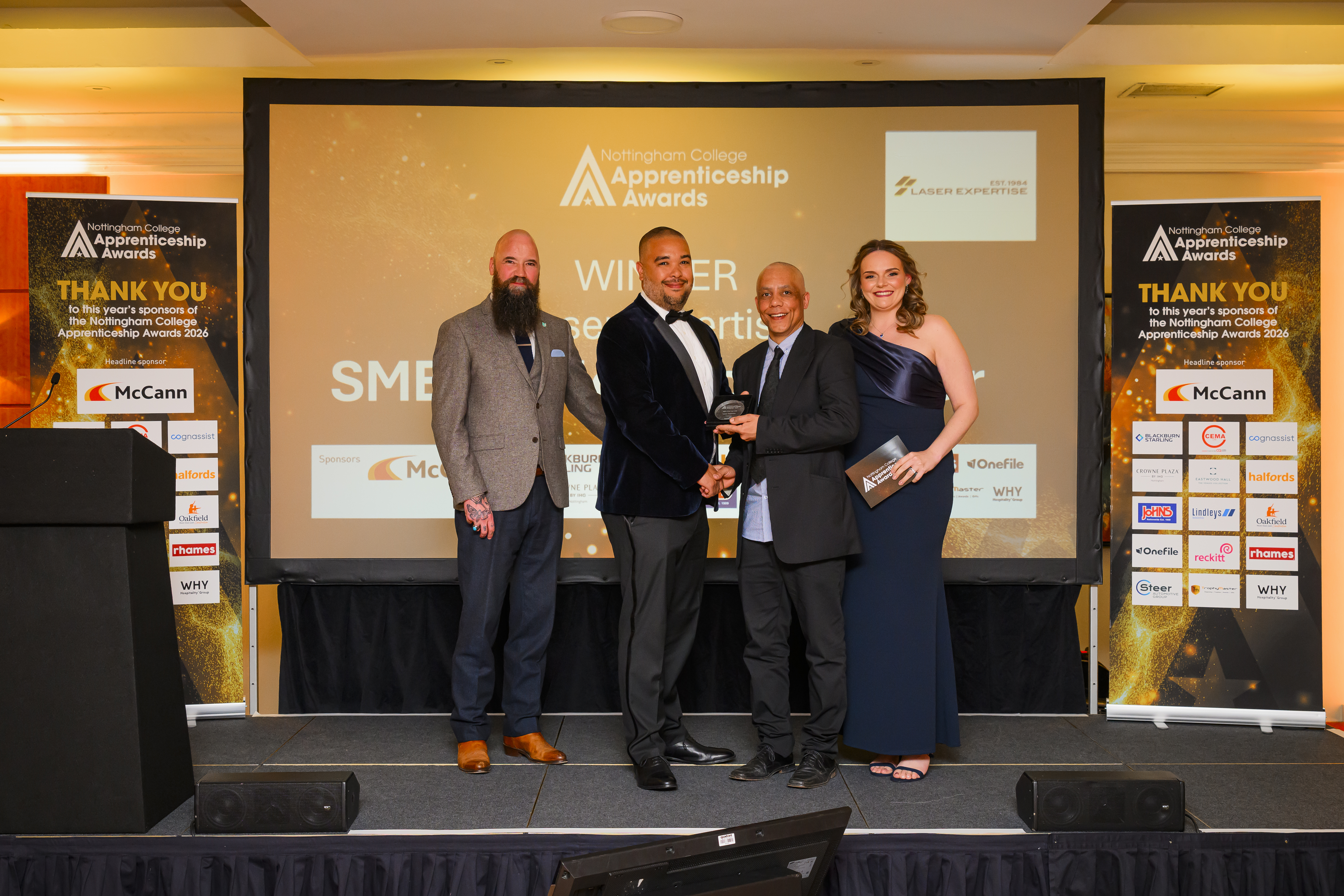 Laser Expertise representative on stage receiving award