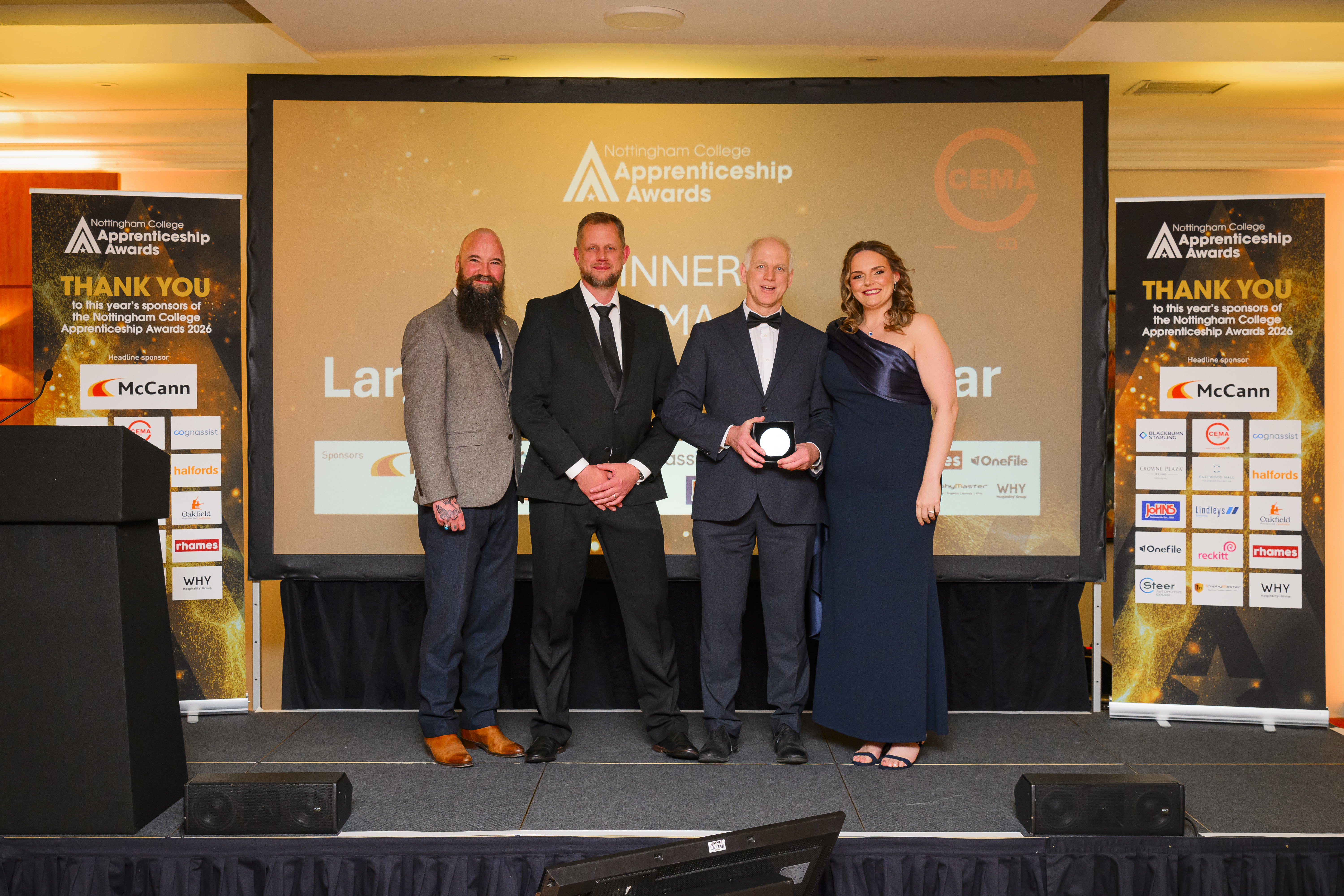 CEMA representative on stage with award