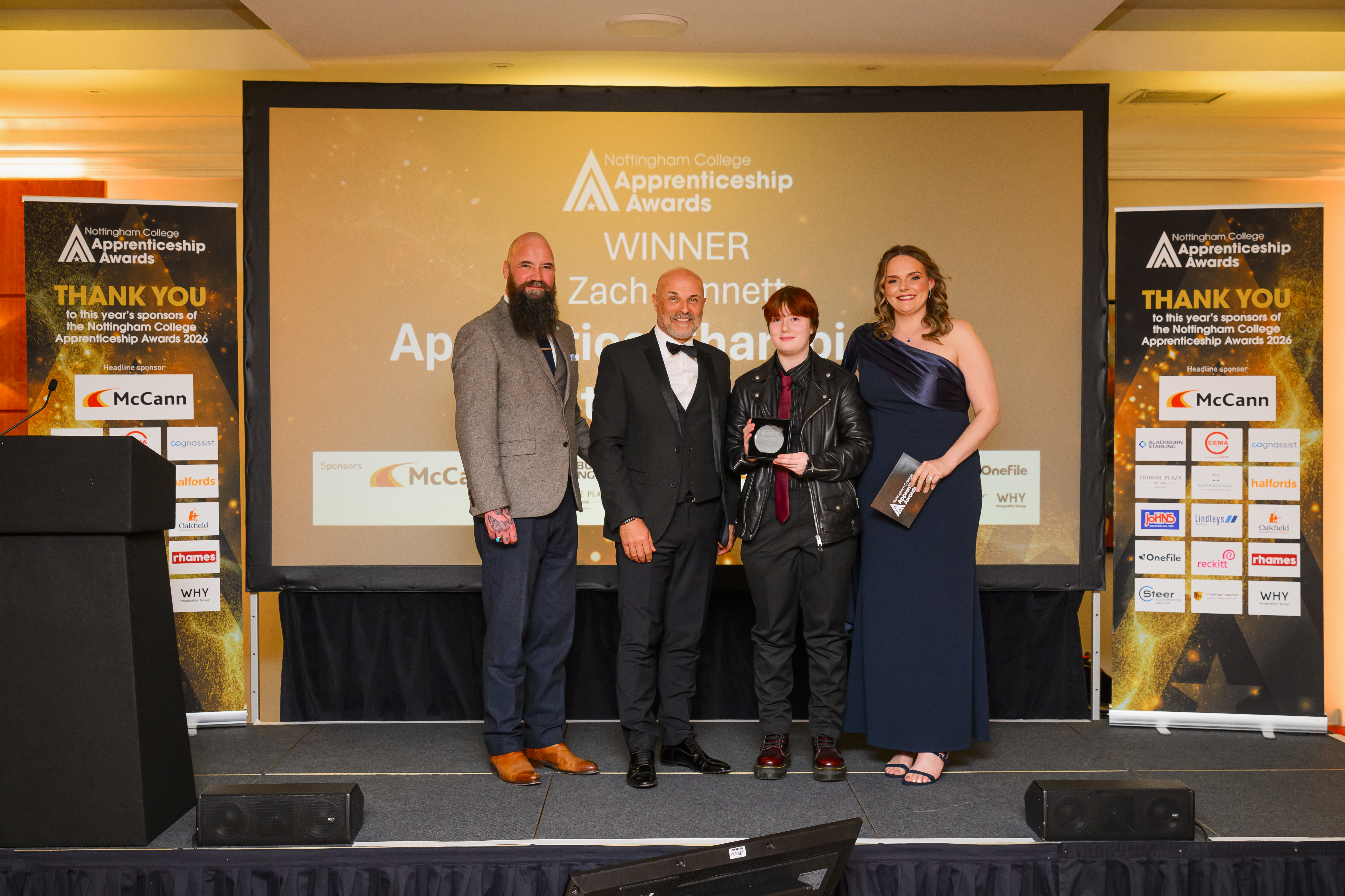 Zach Bennet on stage receiving award