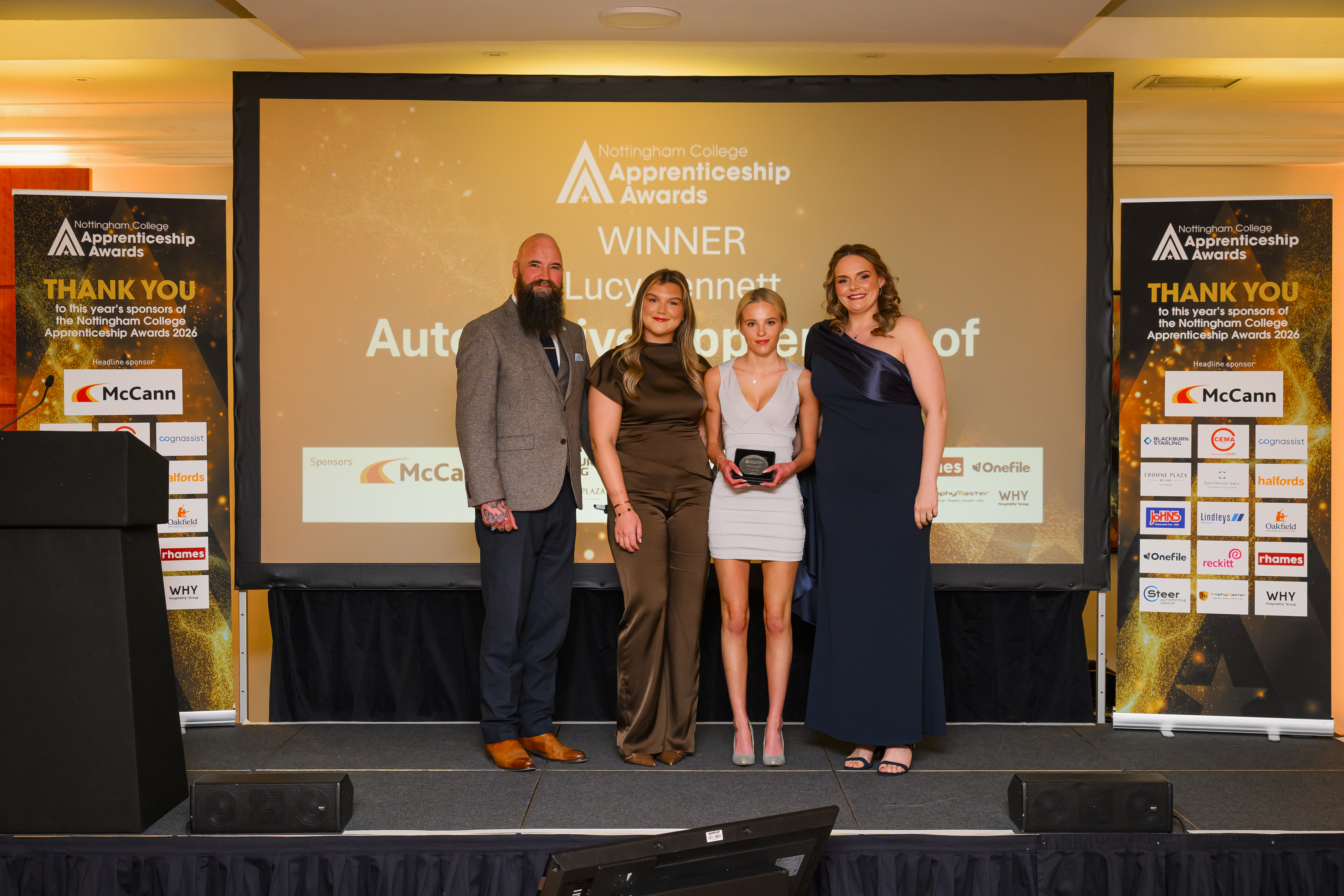 Lucy Bennet on stage receiving award